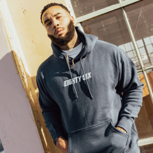 A man with beard waering a eighty six brand hoodie