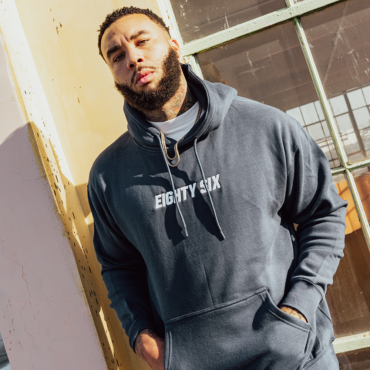 A man with beard waering a eighty six brand hoodie