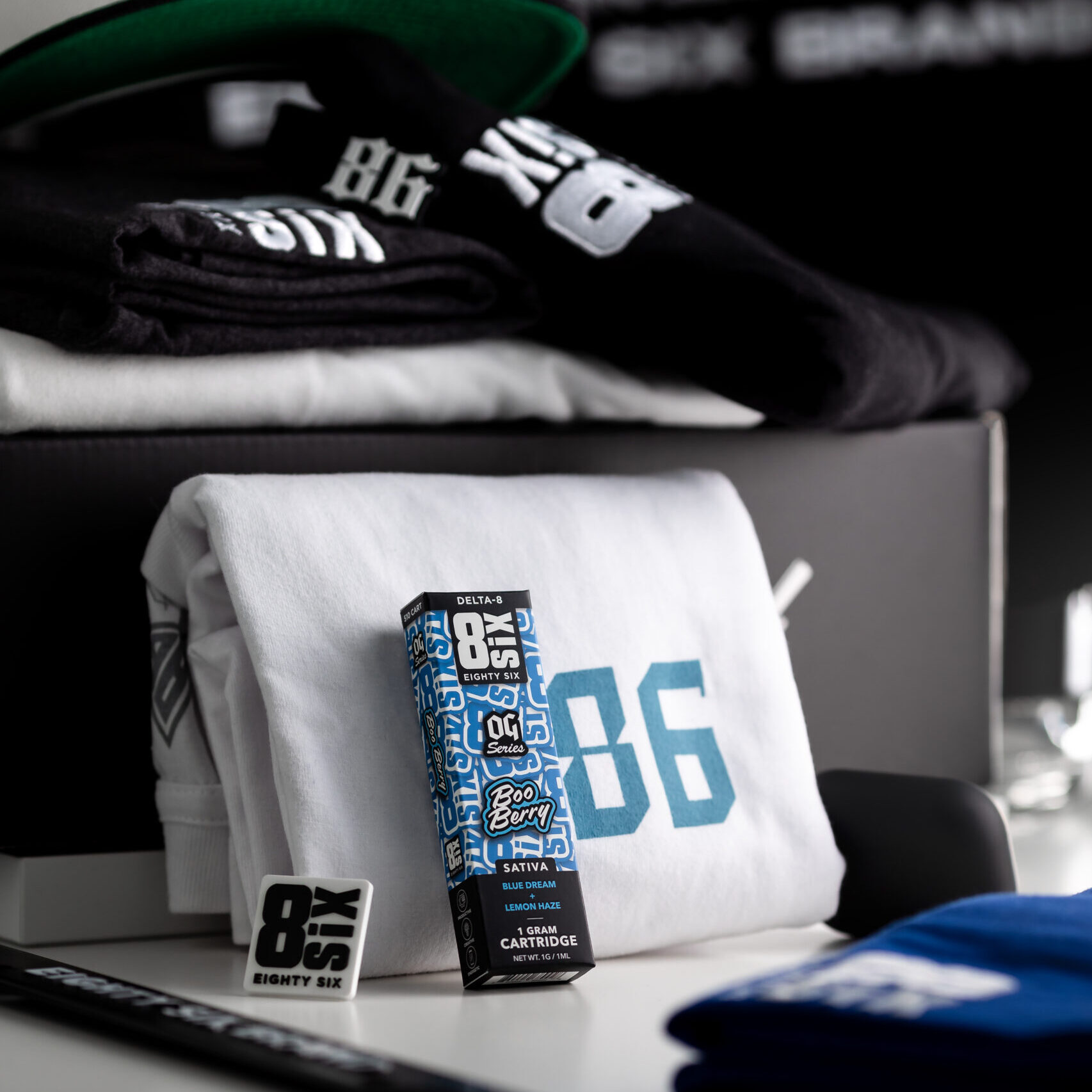 Package of Boo Berry Delta 8 cartridge next to Eighty Six merch