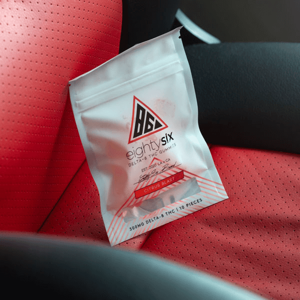 Delta-8 Citrus Blast gummies on a red leather seat