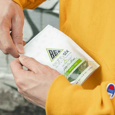 Person opening a bag of Apple Jade gummies