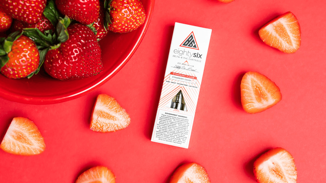 bowl of strawberries with delat-8 thc vape cartridge