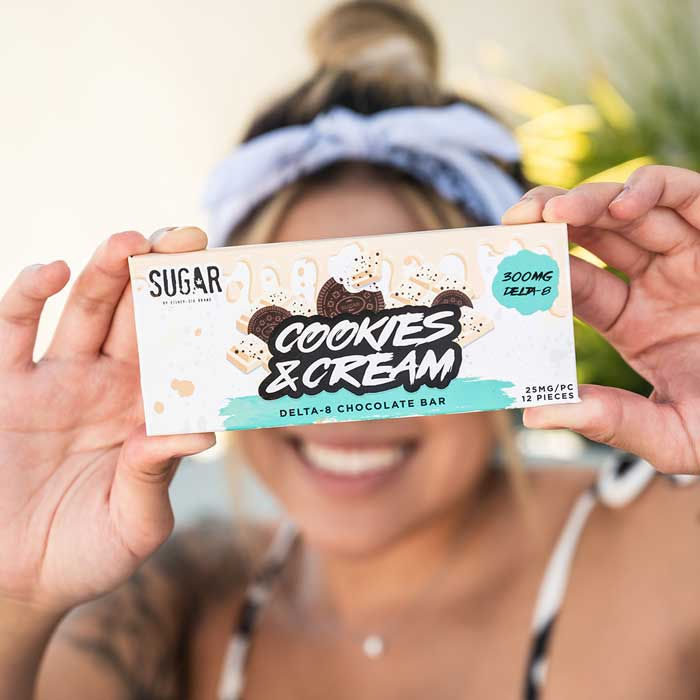  Woman holding the Cookies & Cream Delta-8 chocolate bar 