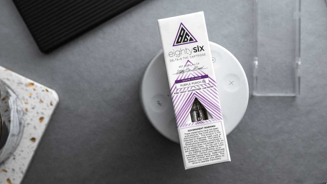 Purple Punch vape cartridge box on a speaker