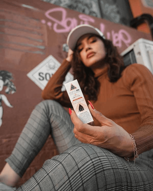 a girl with a Delta-8 cartridge