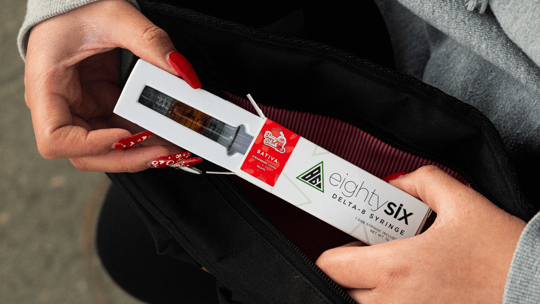 Person unboxing a Delta-8 syringe